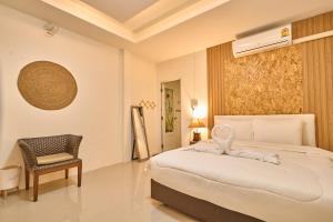 a bedroom with a bed with an elephant on it at Baan Suan ChiChan บ้านสวนชีจรรย์ in Na Jomtien