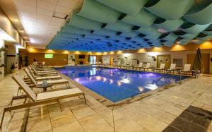 a large pool with chairs and tables in a hotel at Twin Arrows Navajo Casino Resort in Elden Pueblo