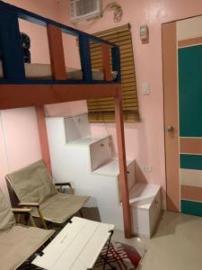 a room with a bunk bed and two beds at Kenjie Apartment in Cordova