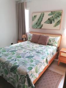 a bedroom with a bed with a green and white comforter at Green Oasis - Dominicus, Bayahibe in La Laguna +14 photos