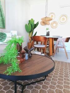 a living room with a table with plants on it at Green Oasis - Dominicus, Bayahibe in La Laguna