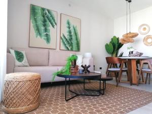 a living room with a couch and a table at Green Oasis - Dominicus, Bayahibe in La Laguna