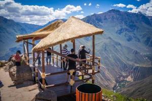 a group of people standing on top of a mountain at Kaypi Yireh in Cabanaconde