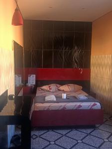 a bedroom with a bed with a cup on it at Hotel Santo Amaro inn in São Paulo