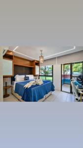 a bedroom with two beds and a large window at Bungalow Frente Mar N 101 in Caucaia +106 photos