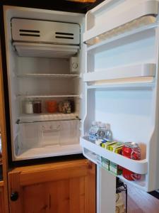 an open refrigerator with its door open and food inside at Garden Suite, self contained, Hunter Valley in Muswellbrook