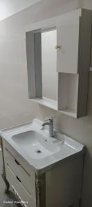 a bathroom with a white sink and a mirror at Mak Palace Hotel in Sialkot +12 photos