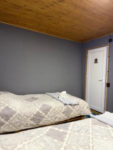 a bedroom with a bed and a wooden ceiling at Sky Tusheti in Omalo