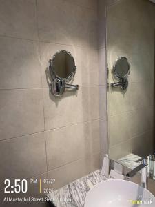 a bathroom with two mirrors and a sink at Arabian Prime in Dubai +10 photos