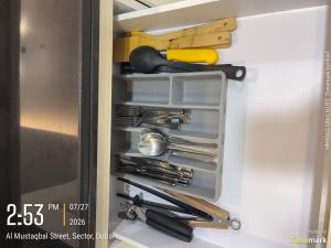 a refrigerator filled with lots of kitchen utensils at Arabian Prime in Dubai
