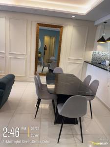 a dining room with a black table and chairs at Arabian Prime in Dubai