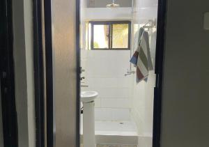 a bathroom with a toilet and a sink at Pizzaro Flats in Lusaka +8 photos