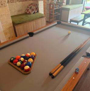 a pool table with a basket of balls on it at DK's Backpacker Hotel in Hoi An