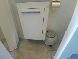 a small bathroom with a toilet with a trash can at Apartma Sonček in Šentjur