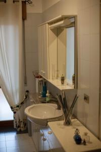 a bathroom with a sink and a mirror at Notti di luna in Potenza