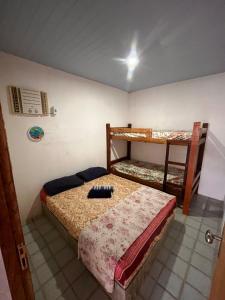 a bedroom with two bunk beds in it at Surf e Café in Cabo de Santo Agostinho