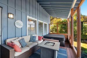 a screened in porch with a couch and a piano at Phenomenal Sunsets Wild Orca & Private Beach in Shelton