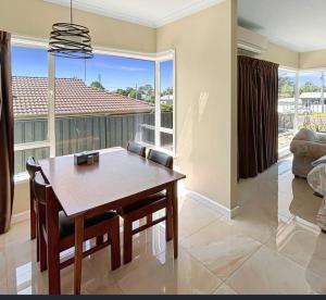 a dining room with a table and a large window at Your gateway to the Lakes in Bairnsdale