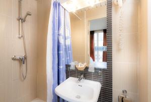 a bathroom with a sink and a shower with a mirror at Hôtel de France Quartier Latin in Paris +92 photos