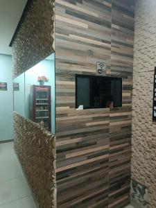 a living room with a wall made out of wood at Hotel Santo Amaro inn in São Paulo
