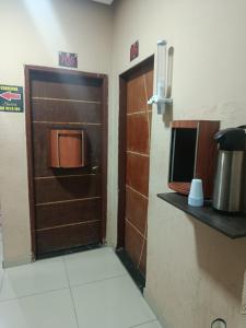 a door in a room with a kitchen with a counter at Hotel Santo Amaro inn in São Paulo