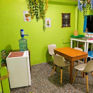 a kitchen with a table and a green wall at Hospedaje doña Gladys in Flores