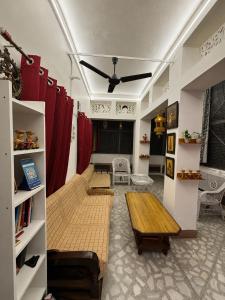 a living room with red curtains and a table at Inka Kashi Hostel Varanasi in Varanasi
