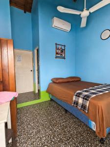 a blue room with a bed and a blue wall at Hospedaje doña Gladys in Flores