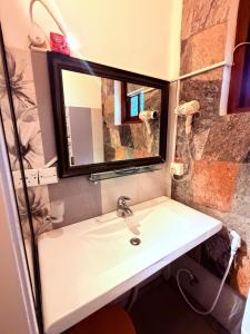a bathroom with a sink and a mirror at White House Ella in Ella +129 photos