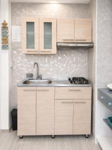 a kitchen with wooden cabinets and a sink at Getaway at Fragata Style with Ocean View in Cartagena de Indias +21 photos