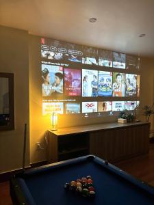a pool table in a living room with a tv at Flick Zone Trung Lực in Lực Hánh