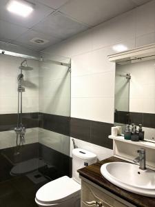 a bathroom with a toilet and a sink and a shower at Flick Zone Trung Lực in Lực Hánh +9 photos