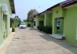 a car parked in the driveway of a building at Pizzaro Flats 2 in Chongwe