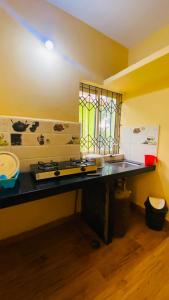 a kitchen with a counter top and a window at Sevrina Beach Inn Calangute in Calangute