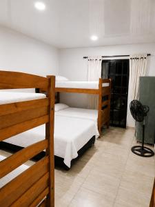 a dorm room with three bunk beds in it at Finca Cabañas el Higueron in Nocaima
