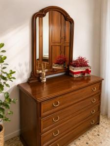 a dresser with a mirror on top of it at Alba Holiday in Vallecorsa