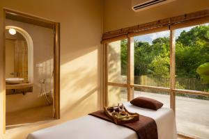 a bedroom with a bed and a large window at Hidden Secrets Dambulla in Dambulla +40 photos