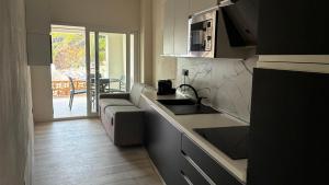 a kitchen with a couch and a sink and a counter at Pareti di mare in Capoliveri