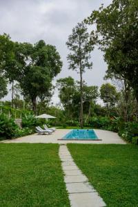 a swimming pool in the middle of a yard at Nine Pines in Pīrmed