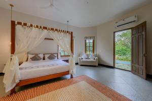 a bedroom with a canopy bed and a couch at Nine Pines in Pīrmed +22 photos