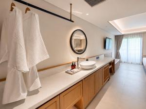 a bathroom with a sink and a mirror at Myneris Hotel, Phuket Karon Beach in Karon Beach +48 photos
