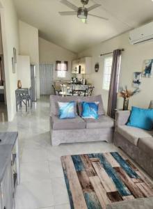 a large living room with two couches and a table at Deluxe Estate in Portmore
