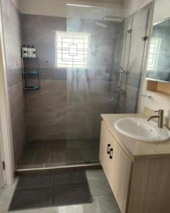 a bathroom with a shower and a sink at Deluxe Estate in Portmore +24 photos