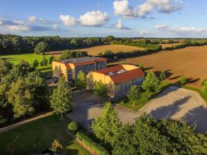 an aerial view of a building in a field at Fjelsted Skov Hotel & Konference in Ejby