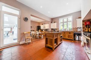 a large kitchen with a table and chairs in it at High House in Norwich