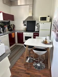 a small kitchen with a white table and chairs at Kuremaa Lake in Kuremaa