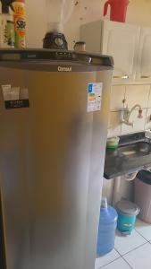 a refrigerator in a kitchen with a sink at Joy Apartamento completo in Salvador +11 photos