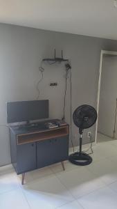a desk and a chair in a room at Joy Apartamento completo in Salvador