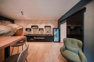a room with a table and chairs and a desk at Historic Residence Barbara in Colle Isarco