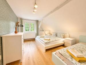 a bedroom with two beds and a couch at Wellness Chalet Luby in Luby